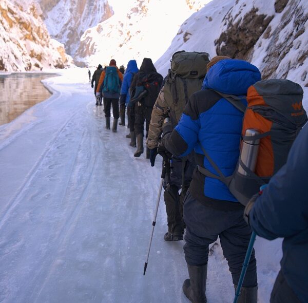 Trekker navigating the icy terrain during the Chadar Trek in Ladakh.