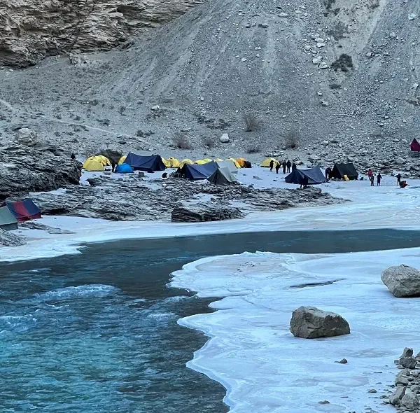 A winter campsite set along the frozen Zanskar River during the Chadar Trek at Tsomo, Ladakh.