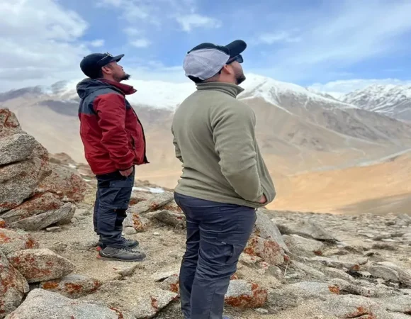 Trekkers admiring the snow-capped mountains near Phyang Village in Ladakh.