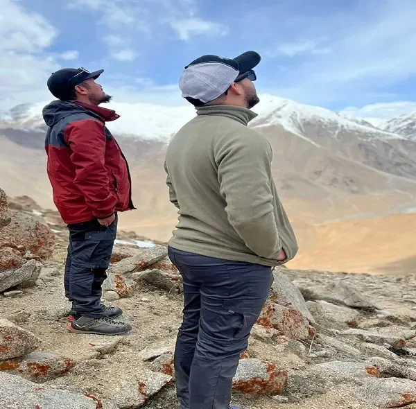 Trekkers admiring the snow-capped mountains near Phyang Village in Ladakh.