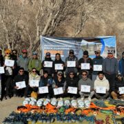 Group of aspiring mountain guides in Ladakh completing a rock climbing course with certifications, showcasing climbing gear and tools.