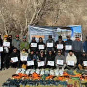 Group of aspiring mountain guides in Ladakh completing a rock climbing course with certifications, showcasing climbing gear and tools.