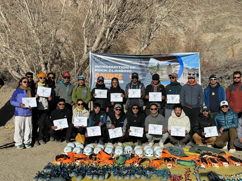 Group of aspiring mountain guides in Ladakh completing a rock climbing course with certifications, showcasing climbing gear and tools.